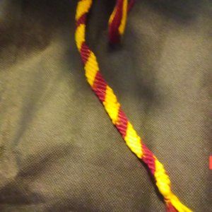 Crimson and gold colored fabric bracelet